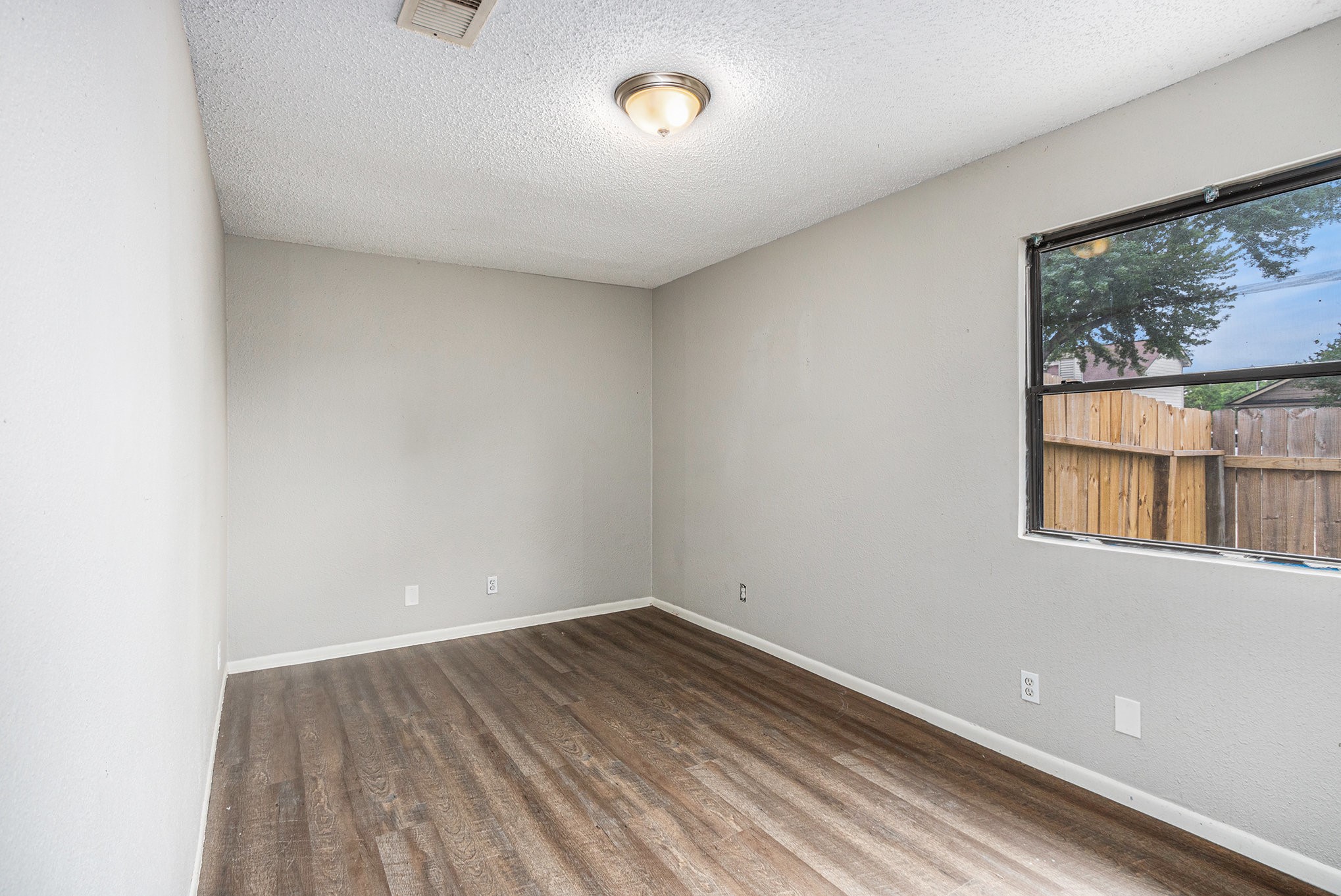 16226 Alden Ridge Drive Houston, TX 77053 - Photo 18 of 22 a view of a room with wooden floor and windows