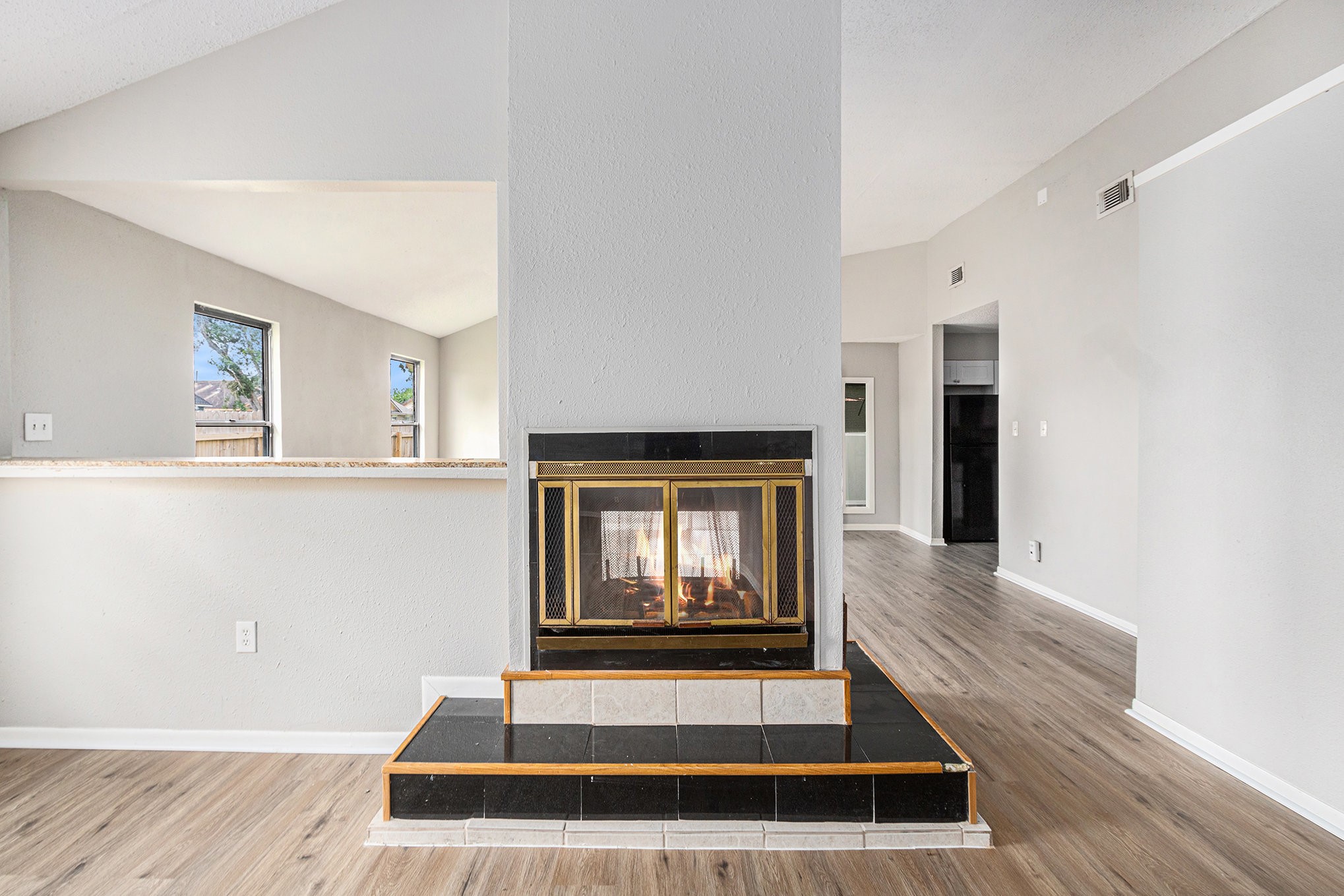 16226 Alden Ridge Drive Houston, TX 77053 - Photo 4 of 22 a living room with a fireplace windows and wooden floor
