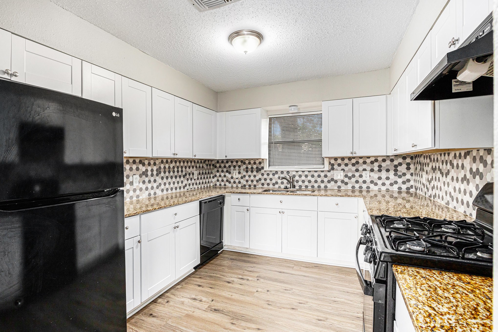 16226 Alden Ridge Drive Houston, TX 77053 - Photo 7 of 22 a kitchen with granite countertop a sink stove and refrigerator