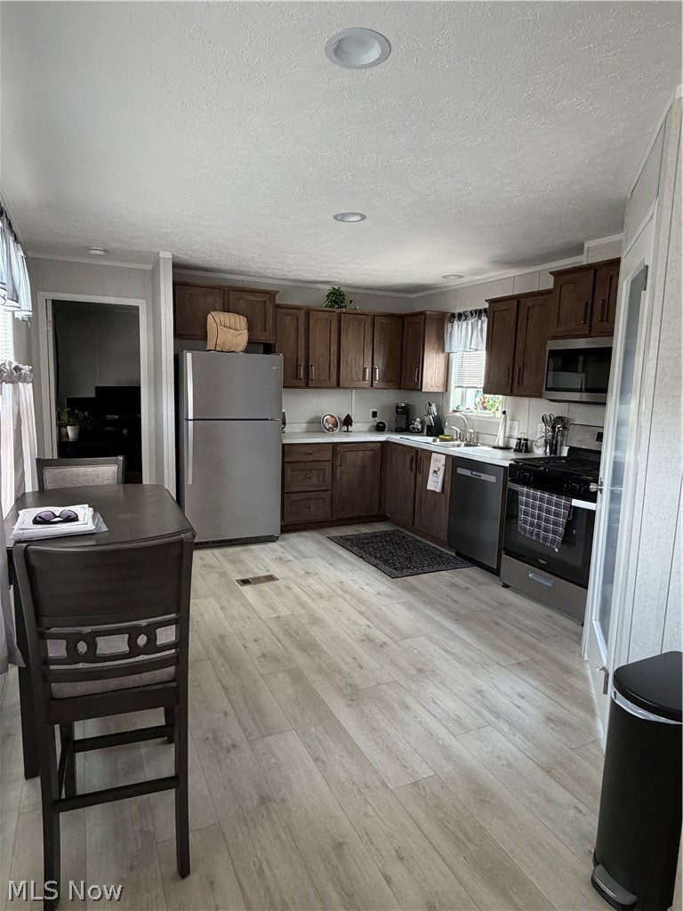 4341 Riverview Road, Unit 62 Peninsula, OH 44264 - Photo 9 of 16 Spacious kitchen featuring, recessed lighting, stainless steel appliances, dark wood-tone cabinetry, and a double basin sink
