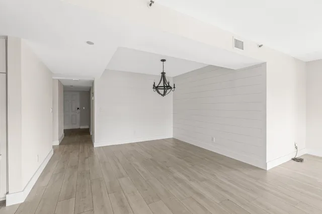 a view of a room with wooden floor