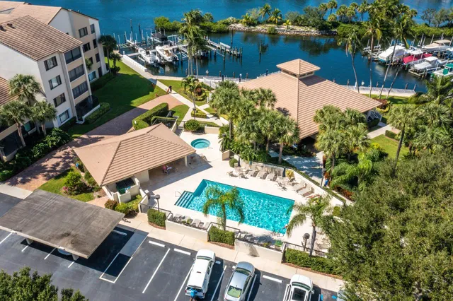 an aerial view of a house with a garden and lake view