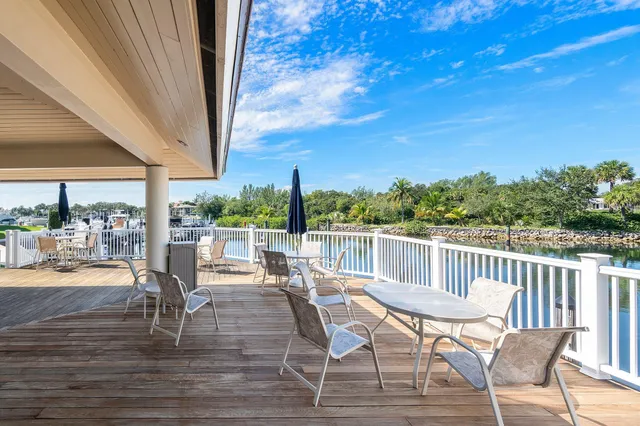 a view of a patio with dining table and chairs with wooden floor