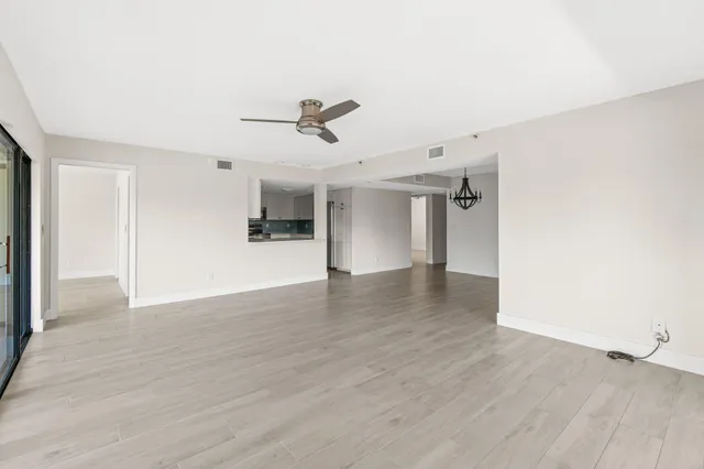 a view of a livingroom with wooden floor and a ceiling fan