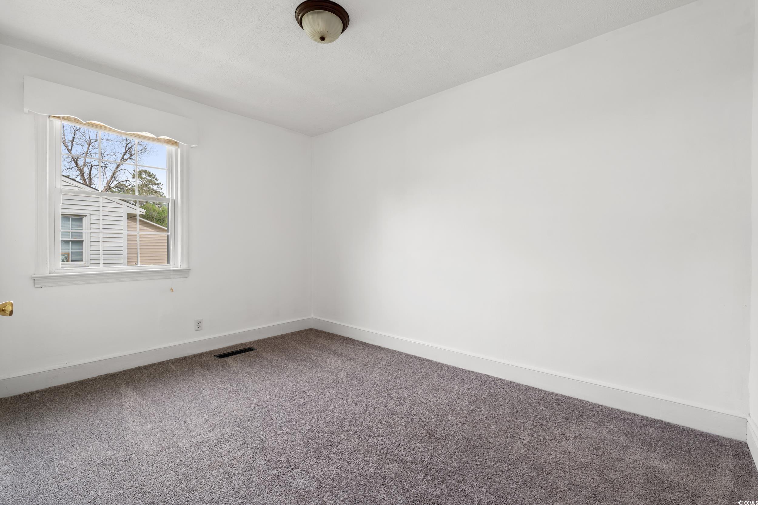 4162 Stevens Street Loris, SC 29569 - Photo 16 of 37 Carpeted spare room with visible vents and baseboa