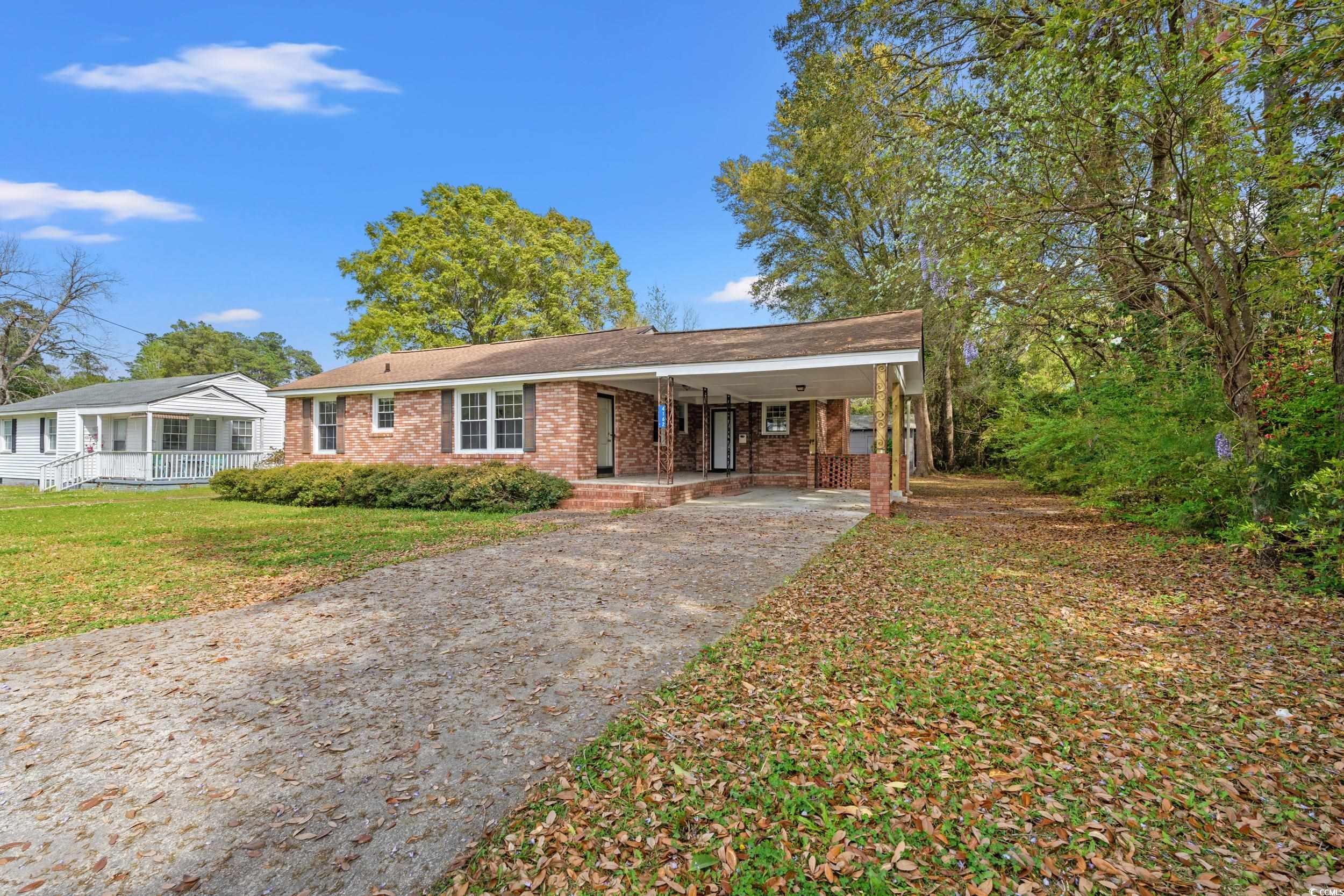 View of front of property with a porch, a front ya