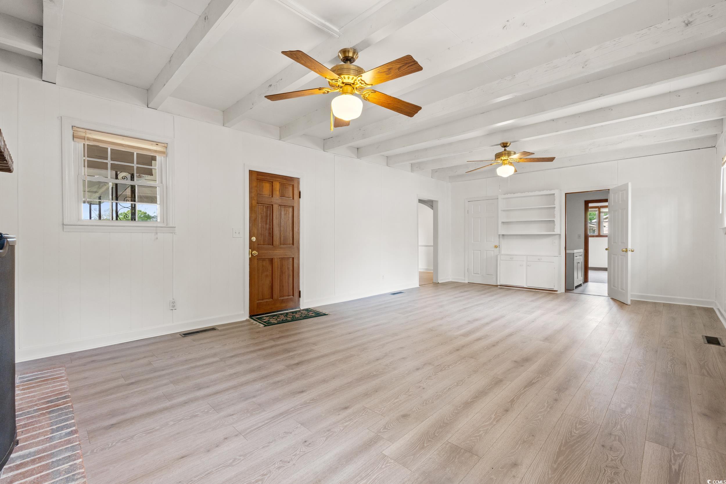 Unfurnished living room with beam ceiling, ceiling