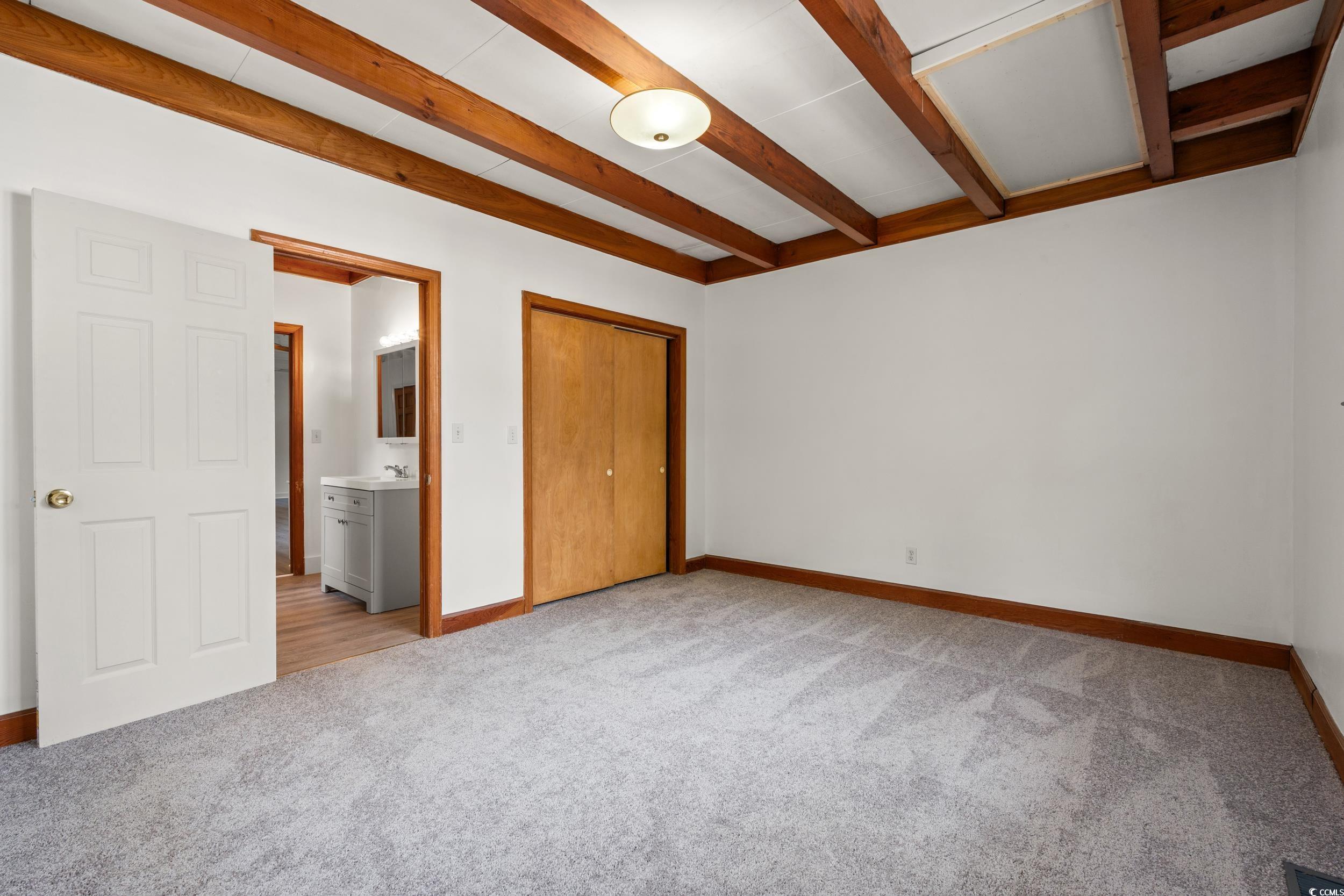 4162 Stevens Street Loris, SC 29569 - Photo 10 of 37 Unfurnished bedroom with beamed ceiling, baseboard