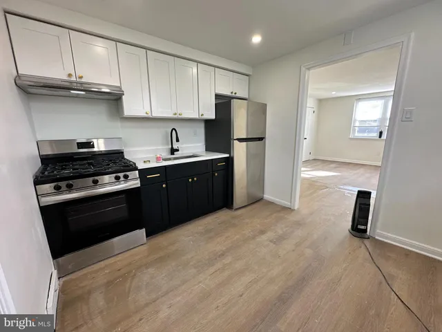 a kitchen with a sink a stove and refrigerator