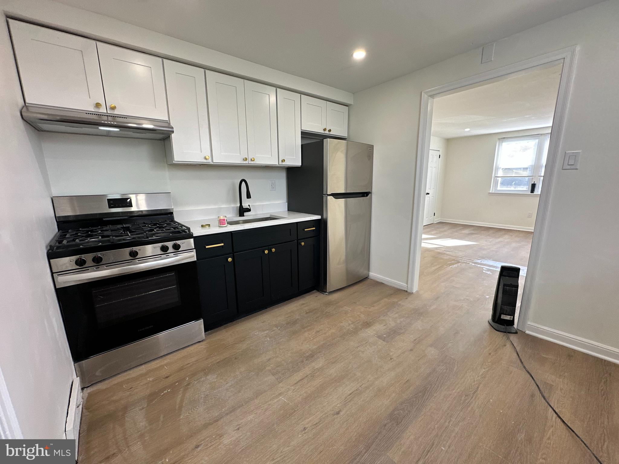 a kitchen with a sink a stove and refrigerator