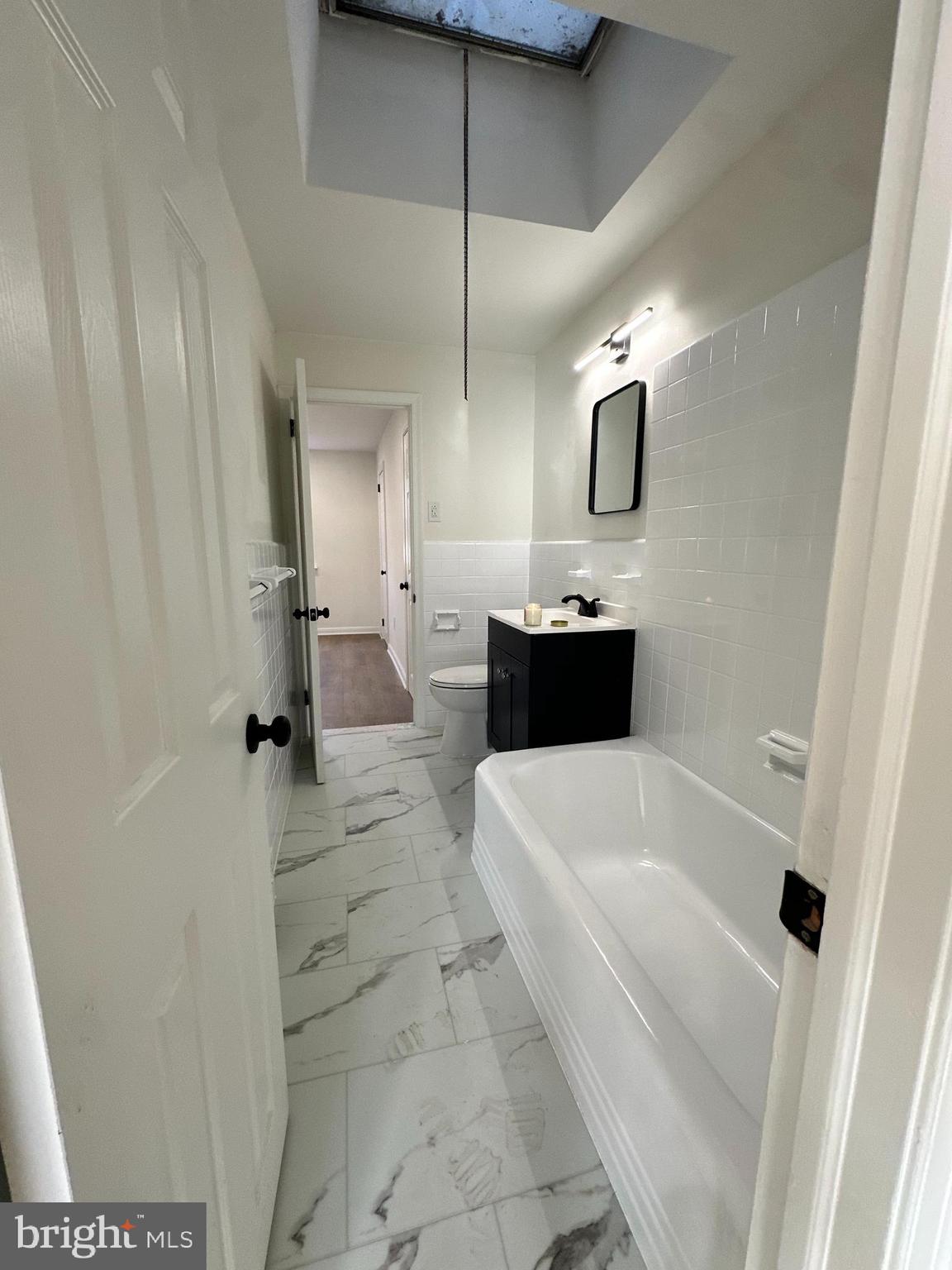 6306 North 8th Street, Unit 2 Philadelphia, PA 19126 - Photo 2 of 3 a bathroom with a bathtub and shower