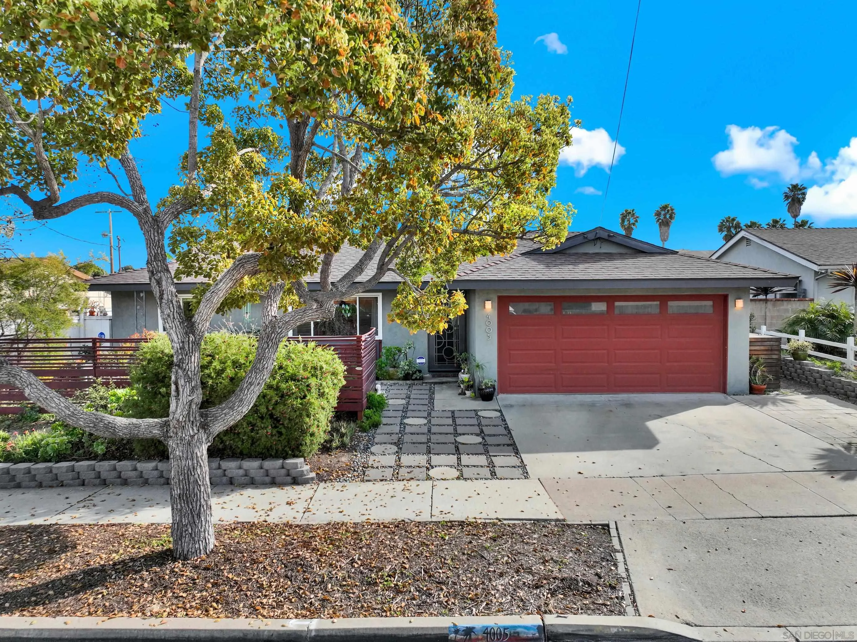 4005 Celeste Drive Oceanside, CA 92056 - Photo 1 of 18 a front view of a house with a yard and garage