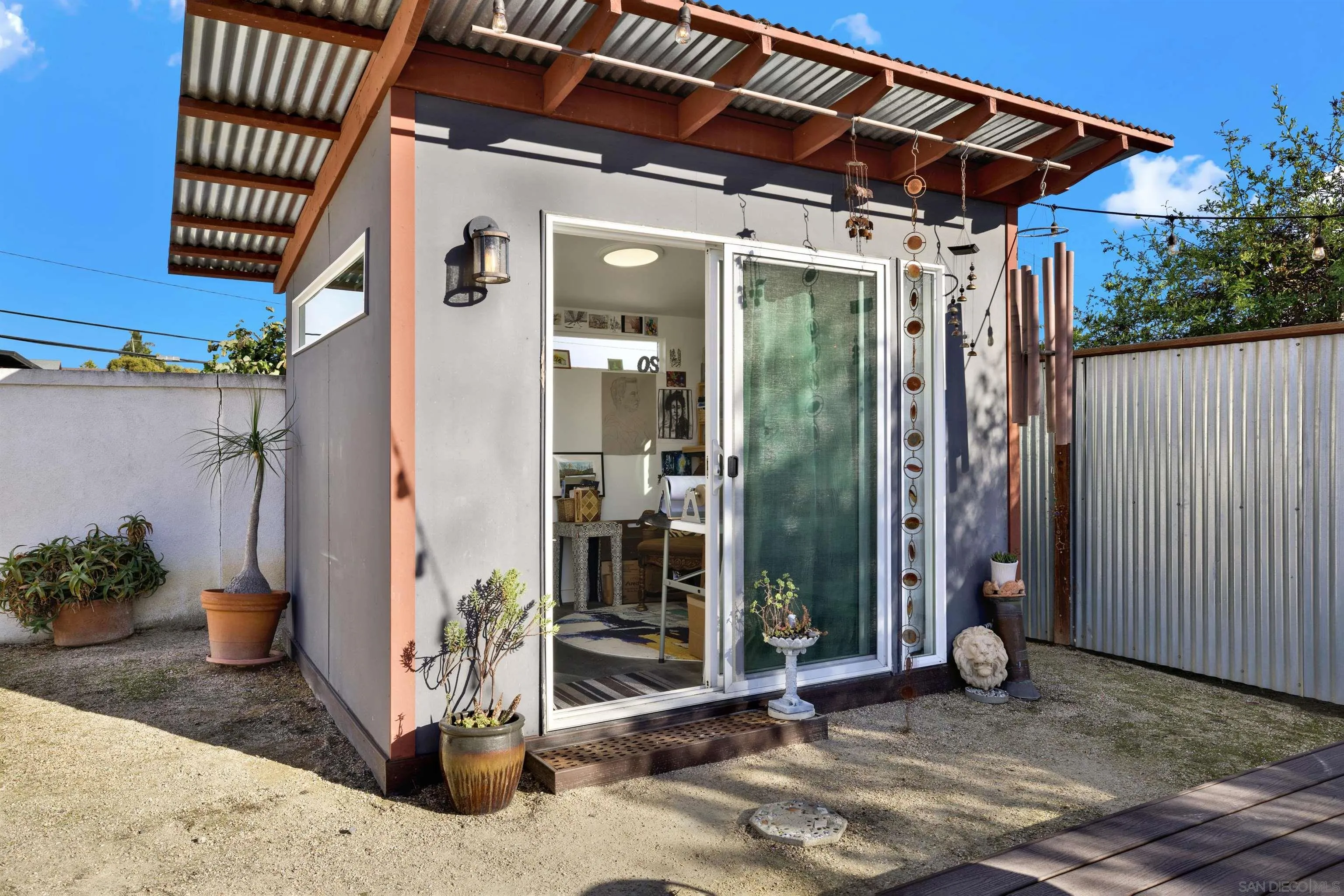 4005 Celeste Drive Oceanside, CA 92056 - Photo 15 of 18 a backyard of a house with potted plants and outdoor seating