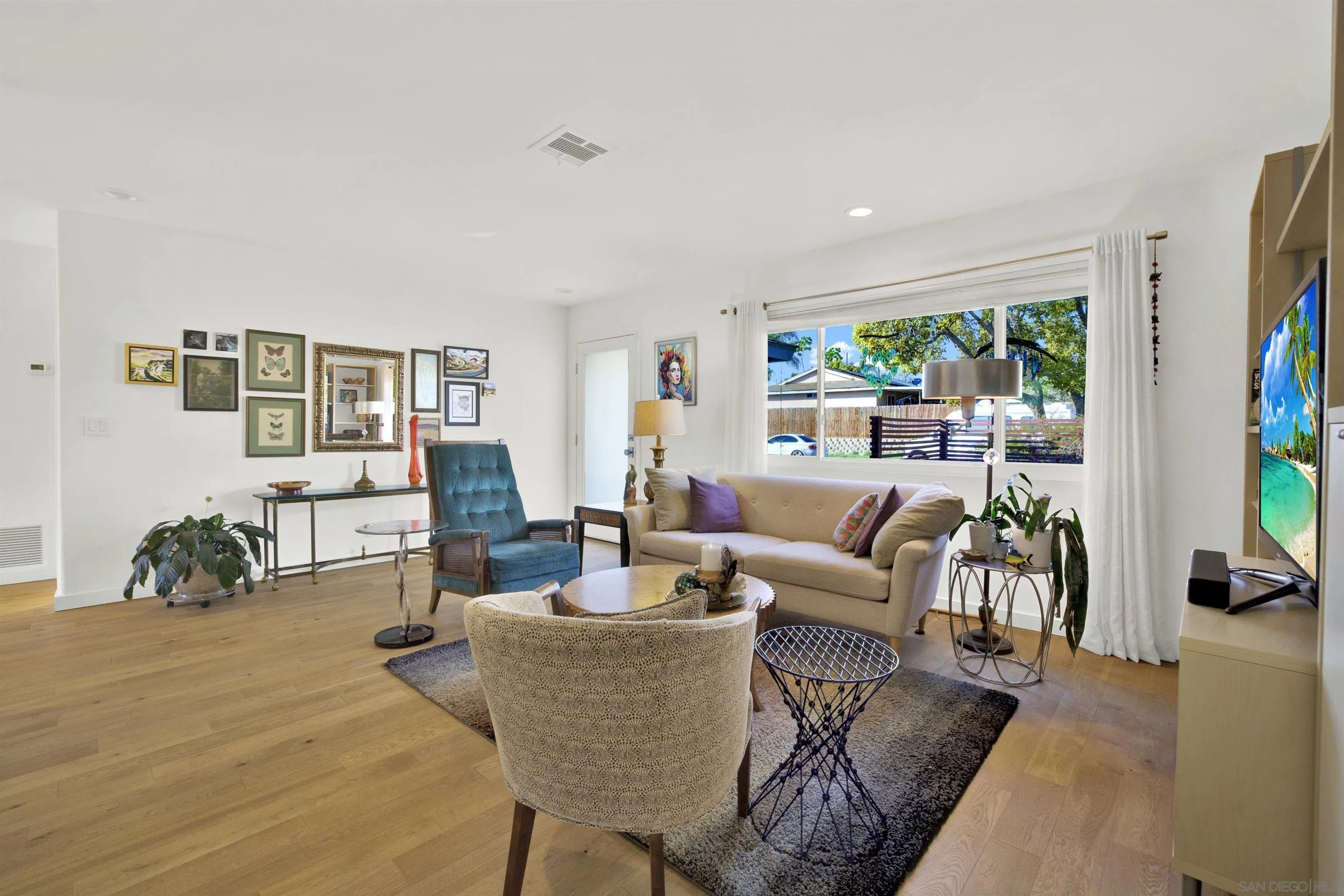 4005 Celeste Drive Oceanside, CA 92056 - Photo 3 of 18 a living room with furniture two large windows and wooden floor