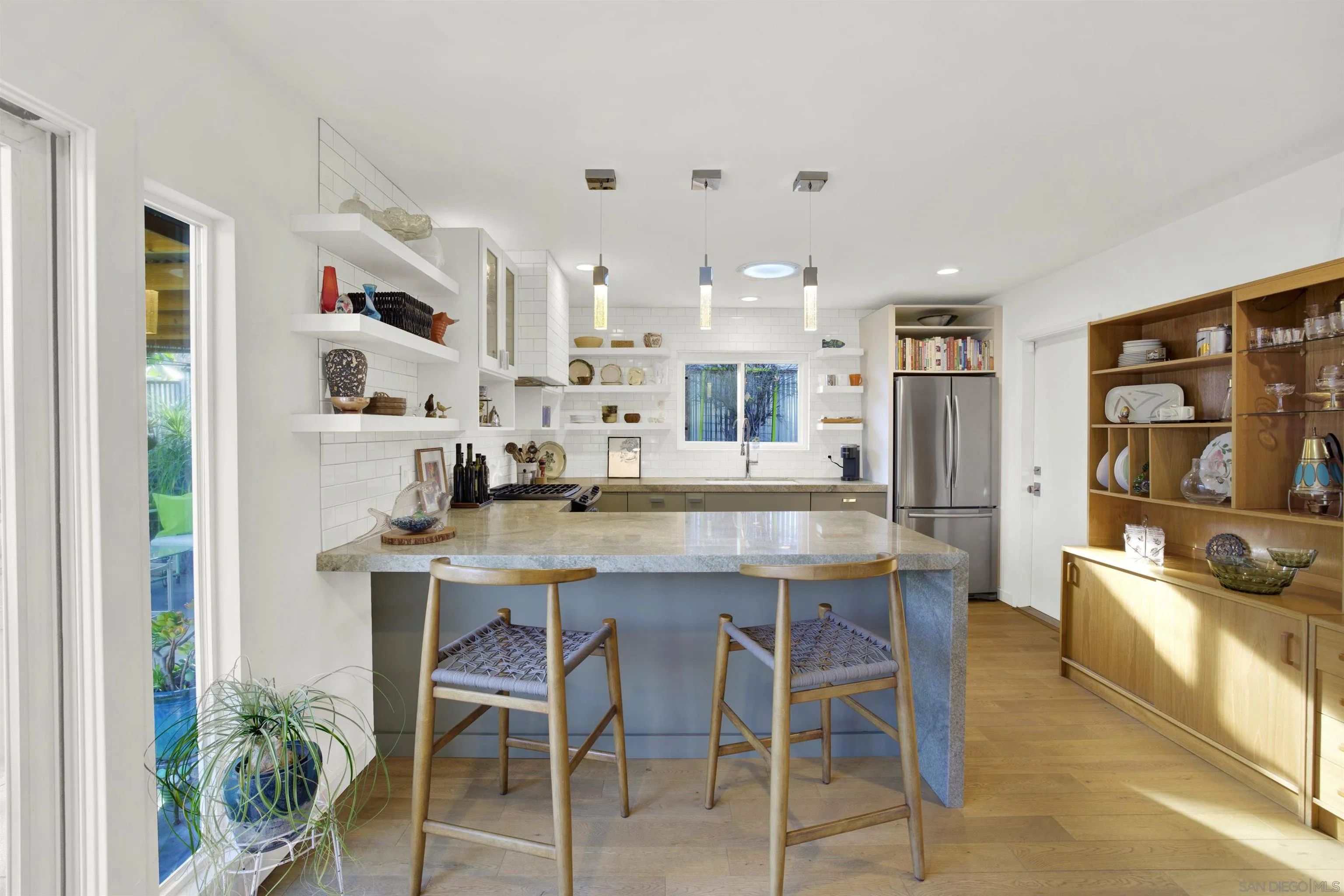 4005 Celeste Drive Oceanside, CA 92056 - Photo 6 of 18 a kitchen with stainless steel appliances kitchen island granite countertop a table and chairs in it
