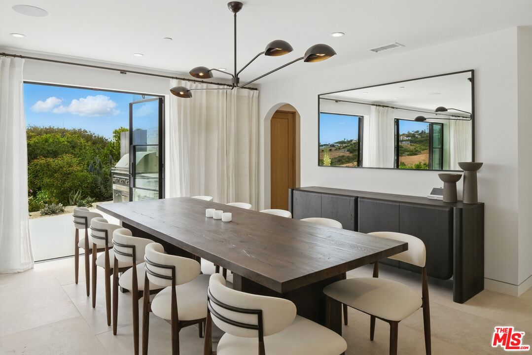6326 Trancas Canyon Road Malibu, CA 90265 - Photo 12 of 53 a view of a dining room with furniture window and wooden floor