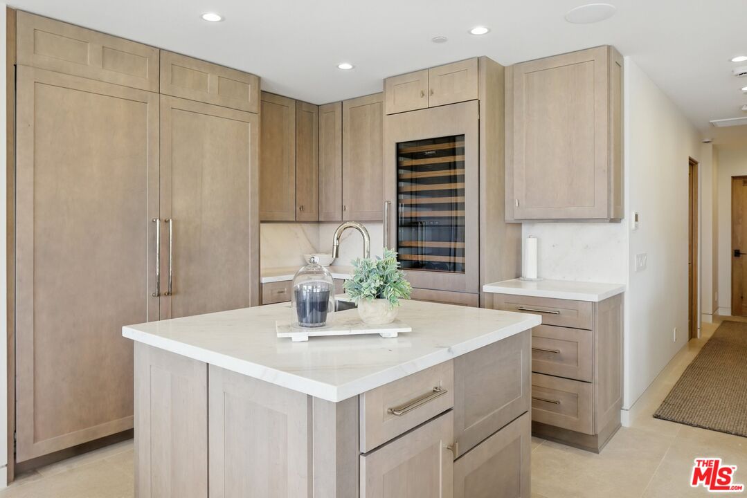 6326 Trancas Canyon Road Malibu, CA 90265 - Photo 14 of 53 a kitchen with kitchen island a sink appliances and cabinets