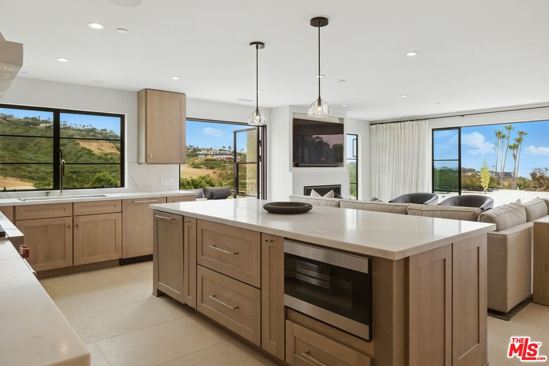 6326 Trancas Canyon Road Malibu, CA 90265 - Photo 19 of 53 a kitchen with a sink stove and cabinets