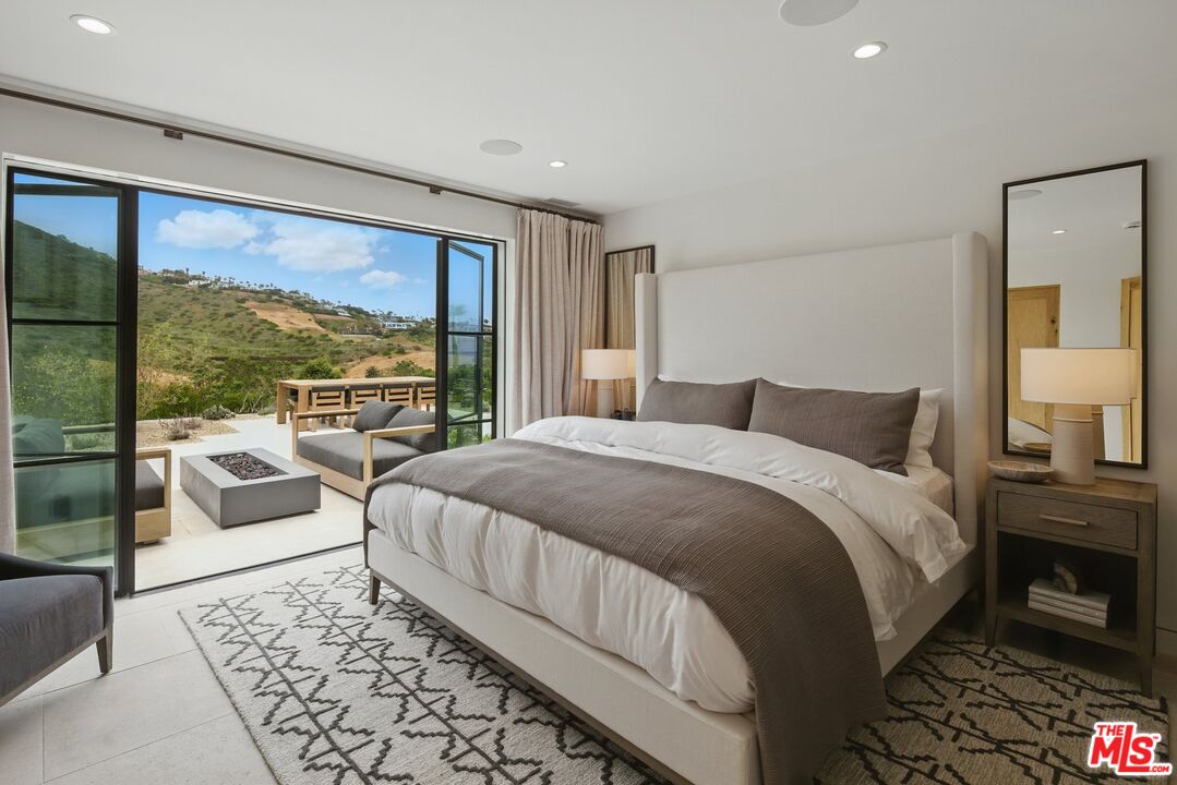 6326 Trancas Canyon Road Malibu, CA 90265 - Photo 24 of 53 a bedroom with a large bed and a large window