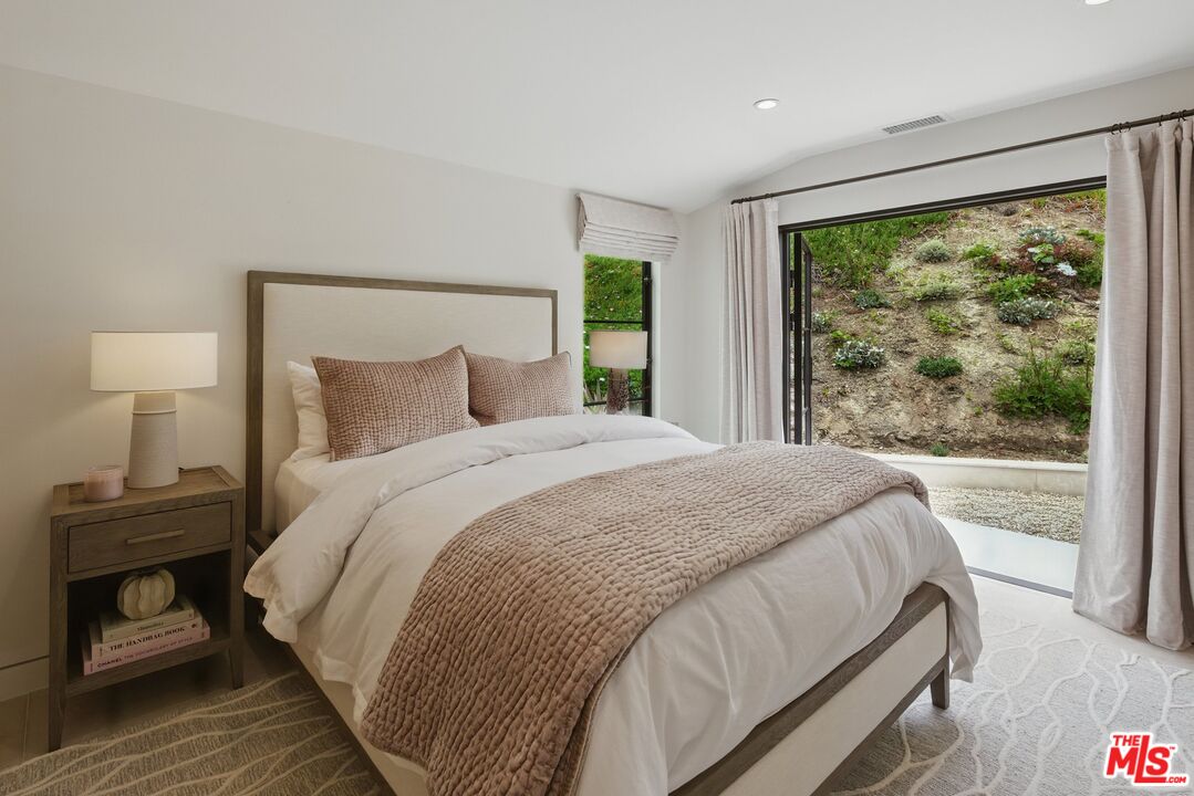 6326 Trancas Canyon Road Malibu, CA 90265 - Photo 30 of 53 a bedroom with a bed and a window