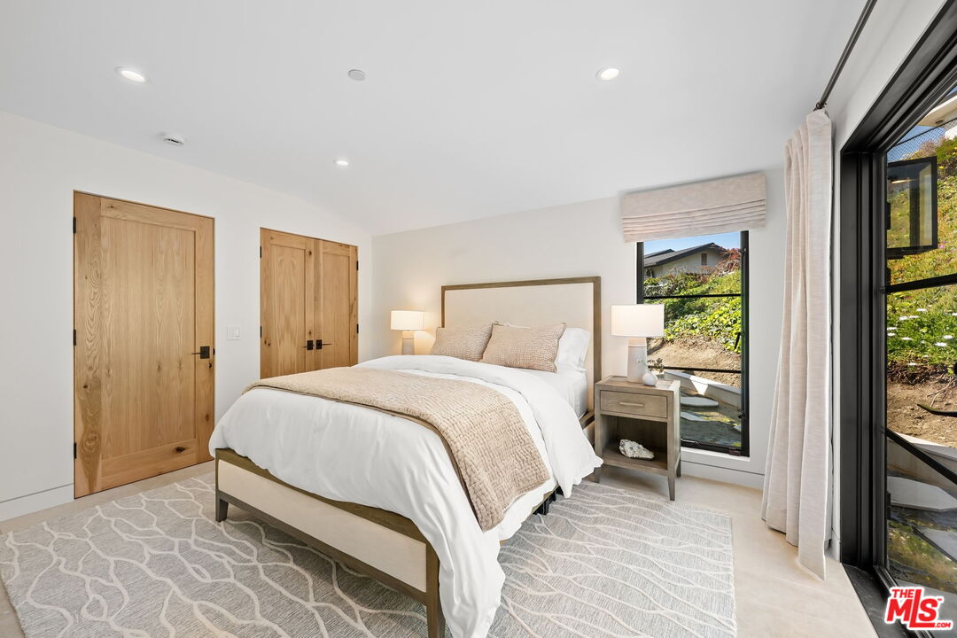 6326 Trancas Canyon Road Malibu, CA 90265 - Photo 31 of 53 a bedroom with a bed and a flat tv screen on dresser