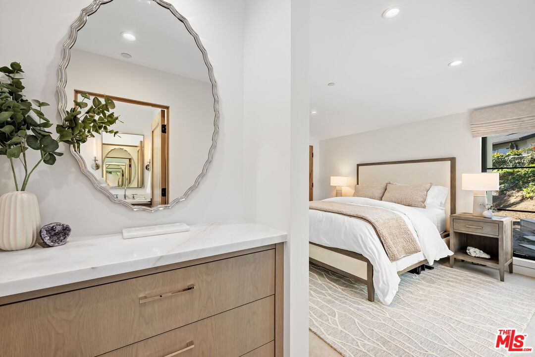 6326 Trancas Canyon Road Malibu, CA 90265 - Photo 32 of 53 a bedroom with a bed and a mirror on dresser