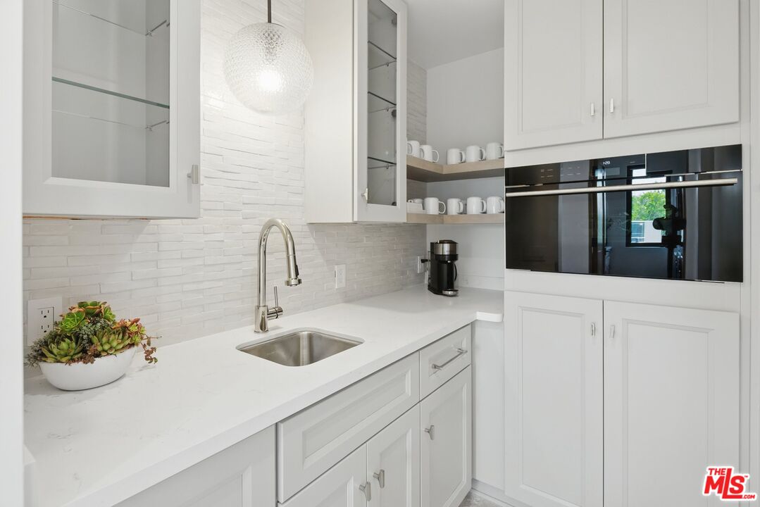 6326 Trancas Canyon Road Malibu, CA 90265 - Photo 40 of 53 a kitchen with stainless steel appliances white cabinets and a sink