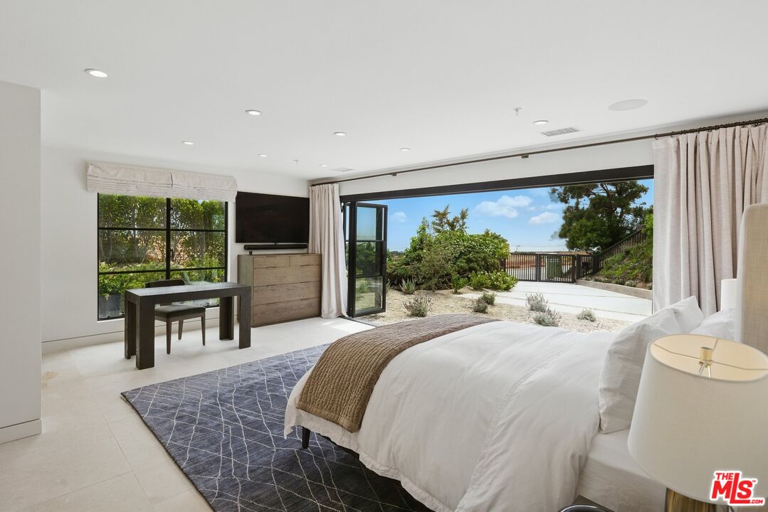 6326 Trancas Canyon Road Malibu, CA 90265 - Photo 42 of 53 a bedroom with a bed and large windows