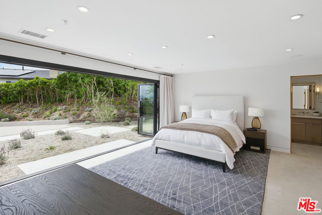 6326 Trancas Canyon Road Malibu, CA 90265 - Photo 44 of 53 a bed sitting in a spacious bedroom next to a window