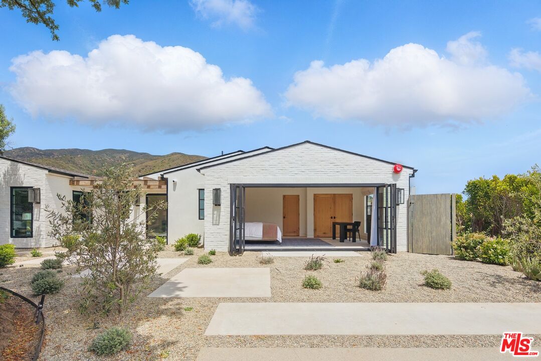 6326 Trancas Canyon Road Malibu, CA 90265 - Photo 46 of 53 a front view of a house with a yard