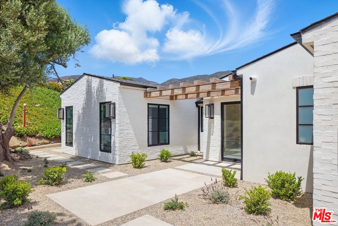 6326 Trancas Canyon Road Malibu, CA 90265 - Photo 47 of 53 a front view of a house with a garden