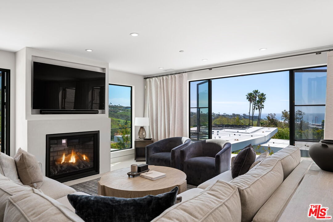 6326 Trancas Canyon Road Malibu, CA 90265 - Photo 8 of 53 a living room with furniture and a fireplace