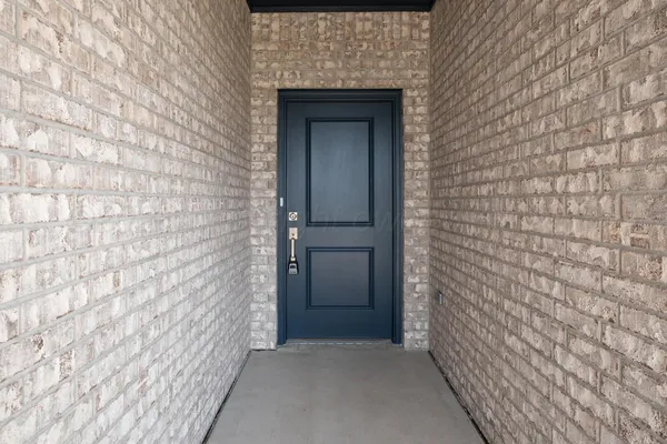 a living room with furniture and a view of kitchen