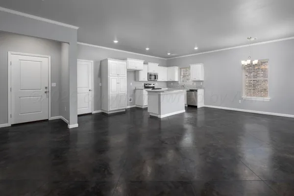 a kitchen with white cabinets appliances and sink
