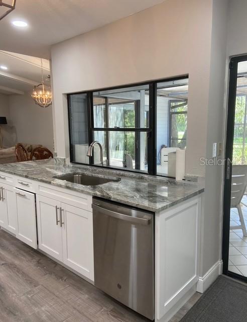 35 Pinewinds Boulevard Oldsmar, FL 34677 - Photo 13 of 36 a kitchen with granite countertop stove sink and cabinets