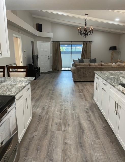 35 Pinewinds Boulevard Oldsmar, FL 34677 - Photo 14 of 36 a kitchen with kitchen island granite countertop a sink cabinets and stainless steel appliances