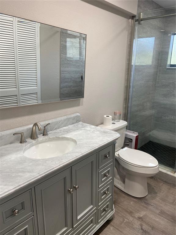 35 Pinewinds Boulevard Oldsmar, FL 34677 - Photo 25 of 36 a bathroom with a granite countertop sink toilet and shower