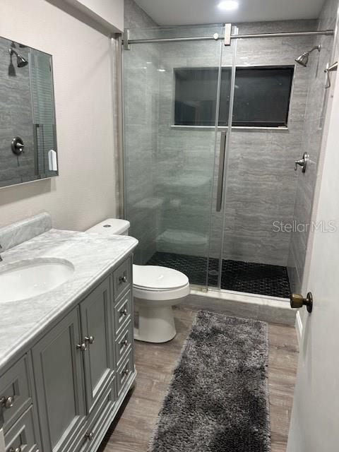 35 Pinewinds Boulevard Oldsmar, FL 34677 - Photo 26 of 36 a bathroom with a sink a toilet a mirror and shower