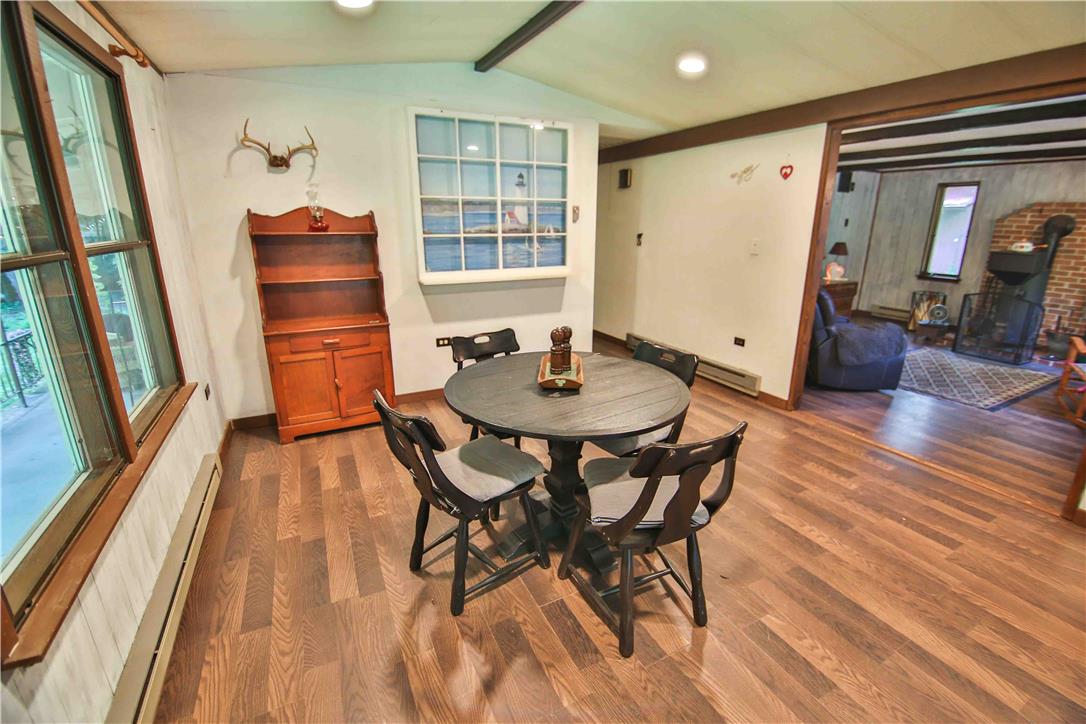 8 Cross Rds Drive Jim Thorpe, PA 18229 - Photo 5 of 32 Rich wood-look flooring grounds this inviting dining space, perfect for gatherings.