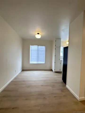 an empty room with windows and entrance