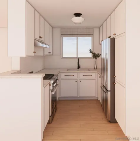a kitchen with a sink a refrigerator a washer dryer and cabinets