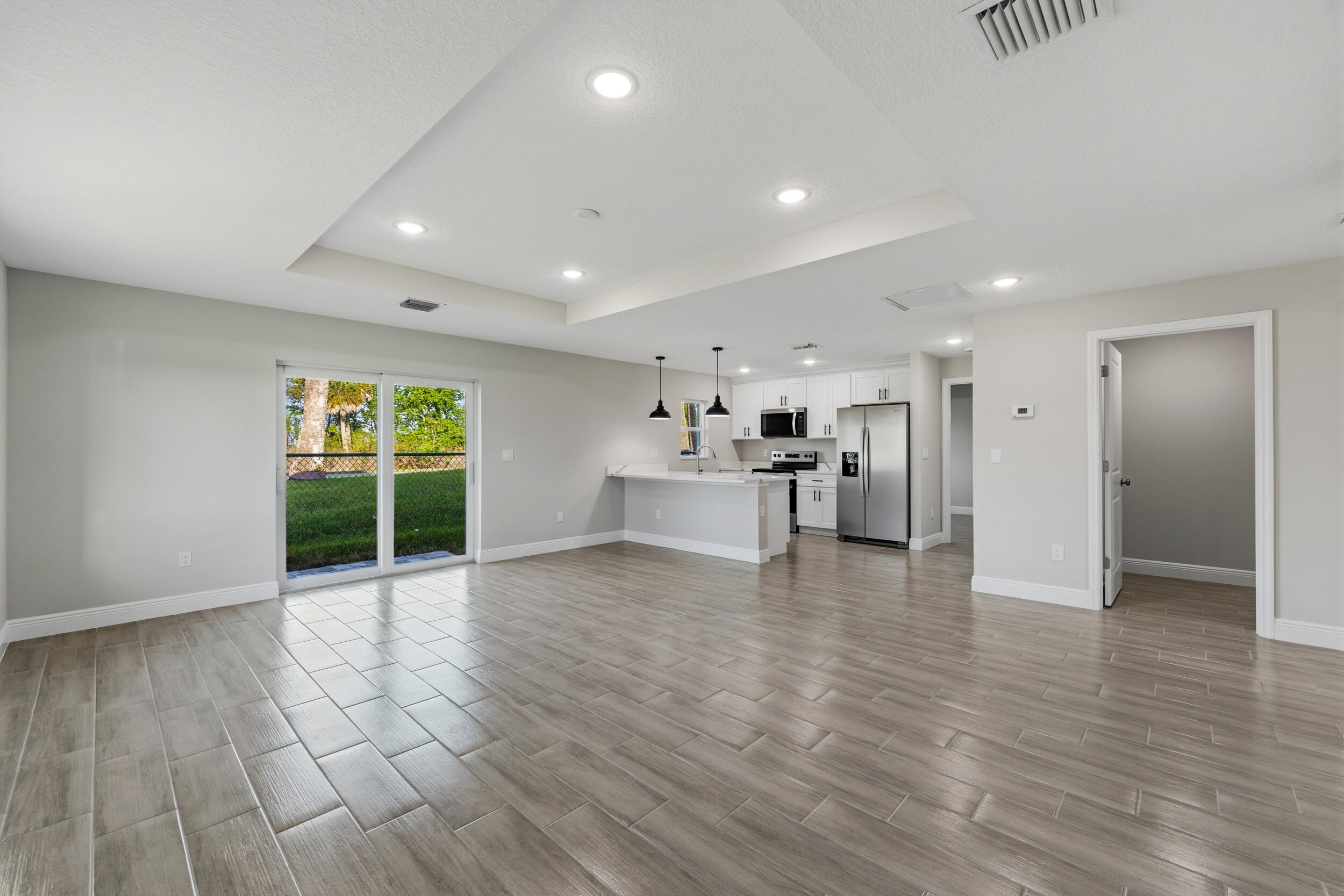 4335 Southwest 15th Way Okeechobee, FL 34974 - Photo 12 of 33 a view of an empty room with wooden floor and a window