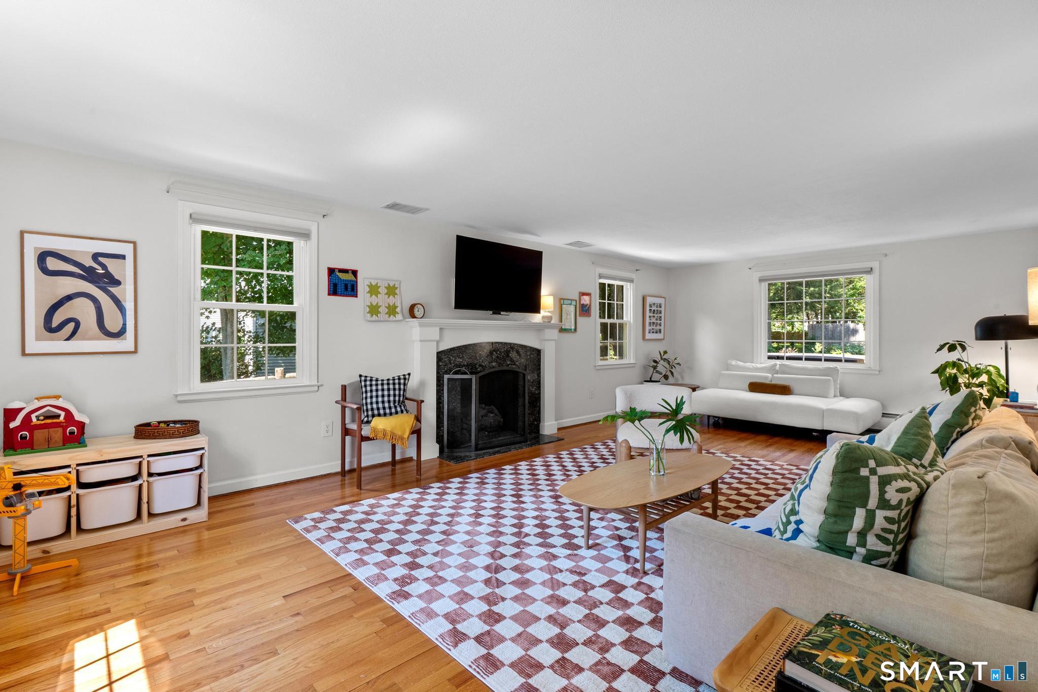 14 Richard Road Simsbury, CT 06070 - Photo 7 of 40 Spacious living room with beautiful natural light, hardwood floors and gas fireplace
