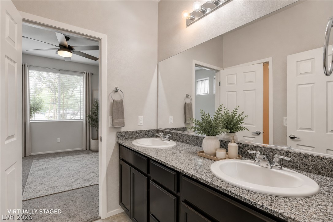2185 Rio Rancho Pointe Place Henderson, NV 89002 - Photo 11 of 17 Jack and Jill Bathrooms- Double vanities with granite counters provide ample space in this well-appointed bathroom.