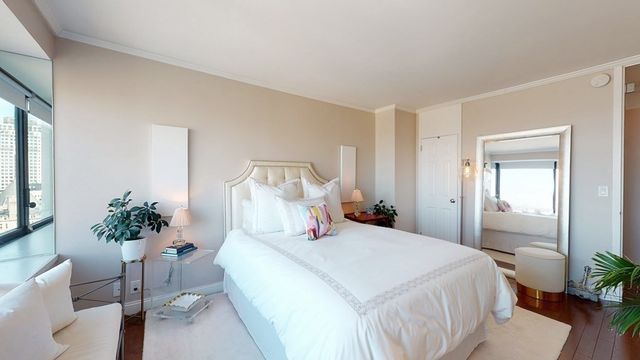 a bedroom with a bed and a potted plant