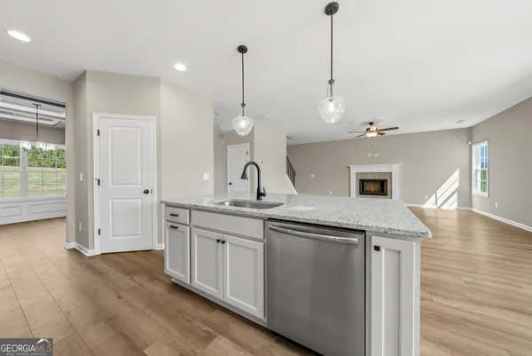 a kitchen with center island and wooden floor