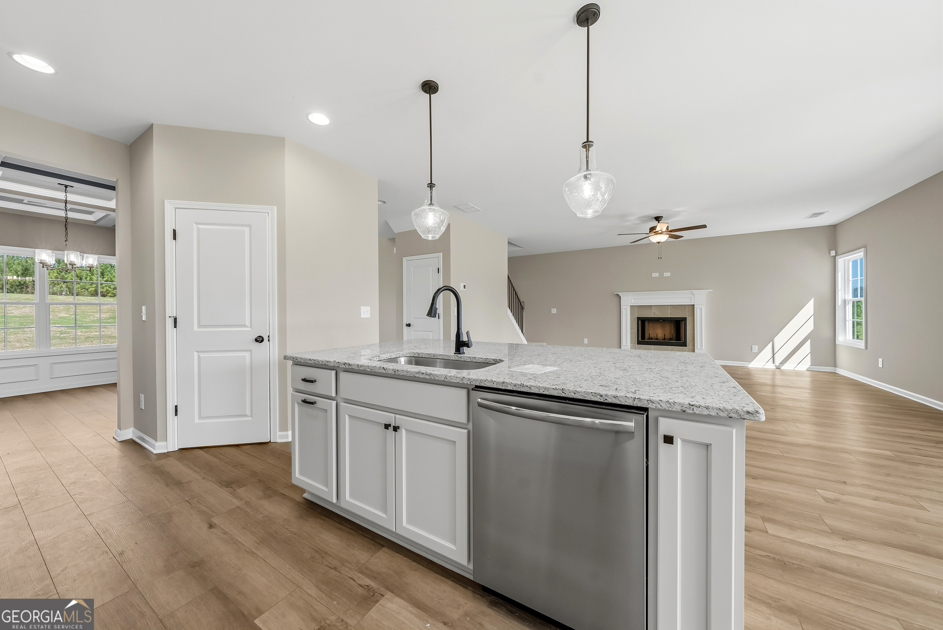 98 Hawkeye Trail, Unit 84 Fortson, GA 31808 - Photo 13 of 42 a kitchen with center island and wooden floor