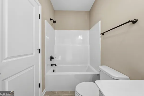 a bathroom with a toilet and a bathtub