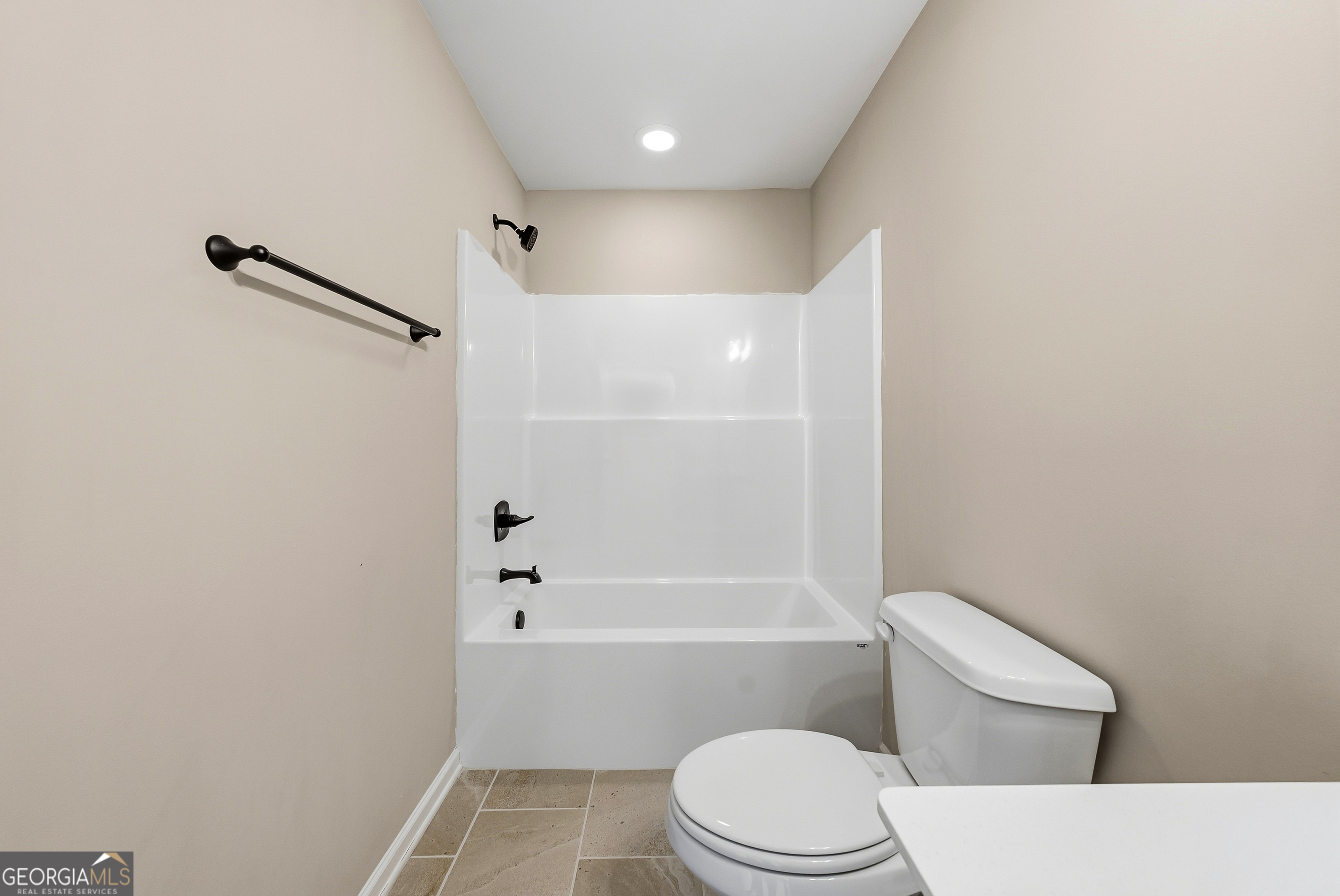 98 Hawkeye Trail, Unit 84 Fortson, GA 31808 - Photo 33 of 42 a white toilet sitting next to a bath tub