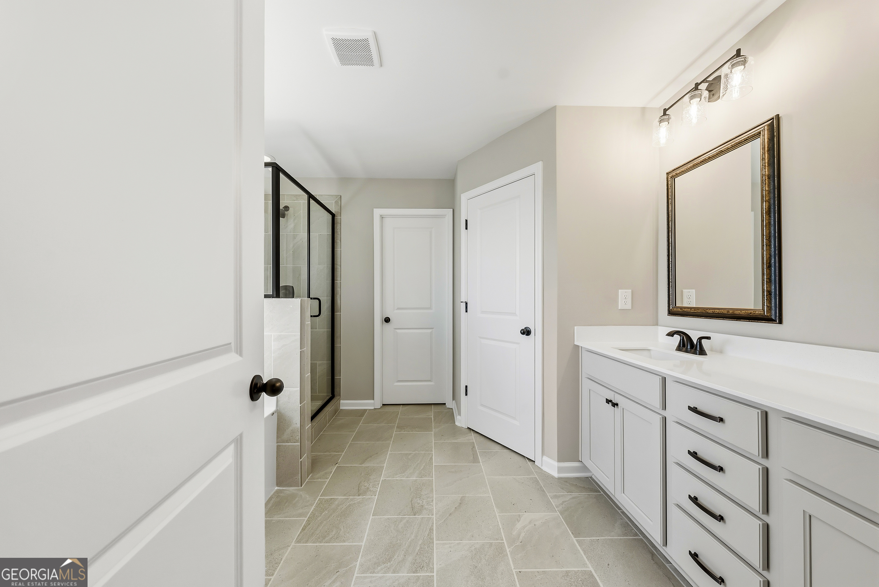 98 Hawkeye Trail, Unit 84 Fortson, GA 31808 - Photo 36 of 42 a bathroom with a double vanity sink mirror and shower